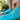 Close-up of a person wearing bright turquoise athletic socks with text and patterns, standing on a smooth surface. A running shoe is blurred in the background, suggesting a sporty and active vibe.