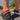Close-up of colorful athletic socks in sneakers standing on pavement. 